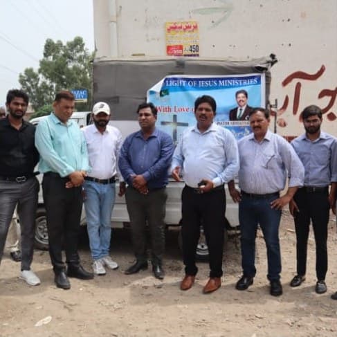 The relief team standing together in front of the truck