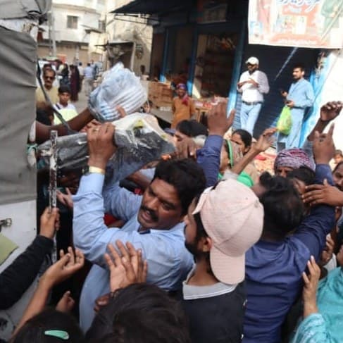 Volunteers handing out parcels from the back of the relief truck