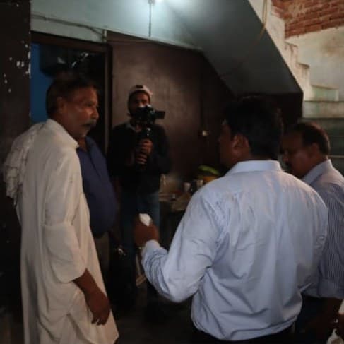 The team visiting a family inside their fire-damaged home