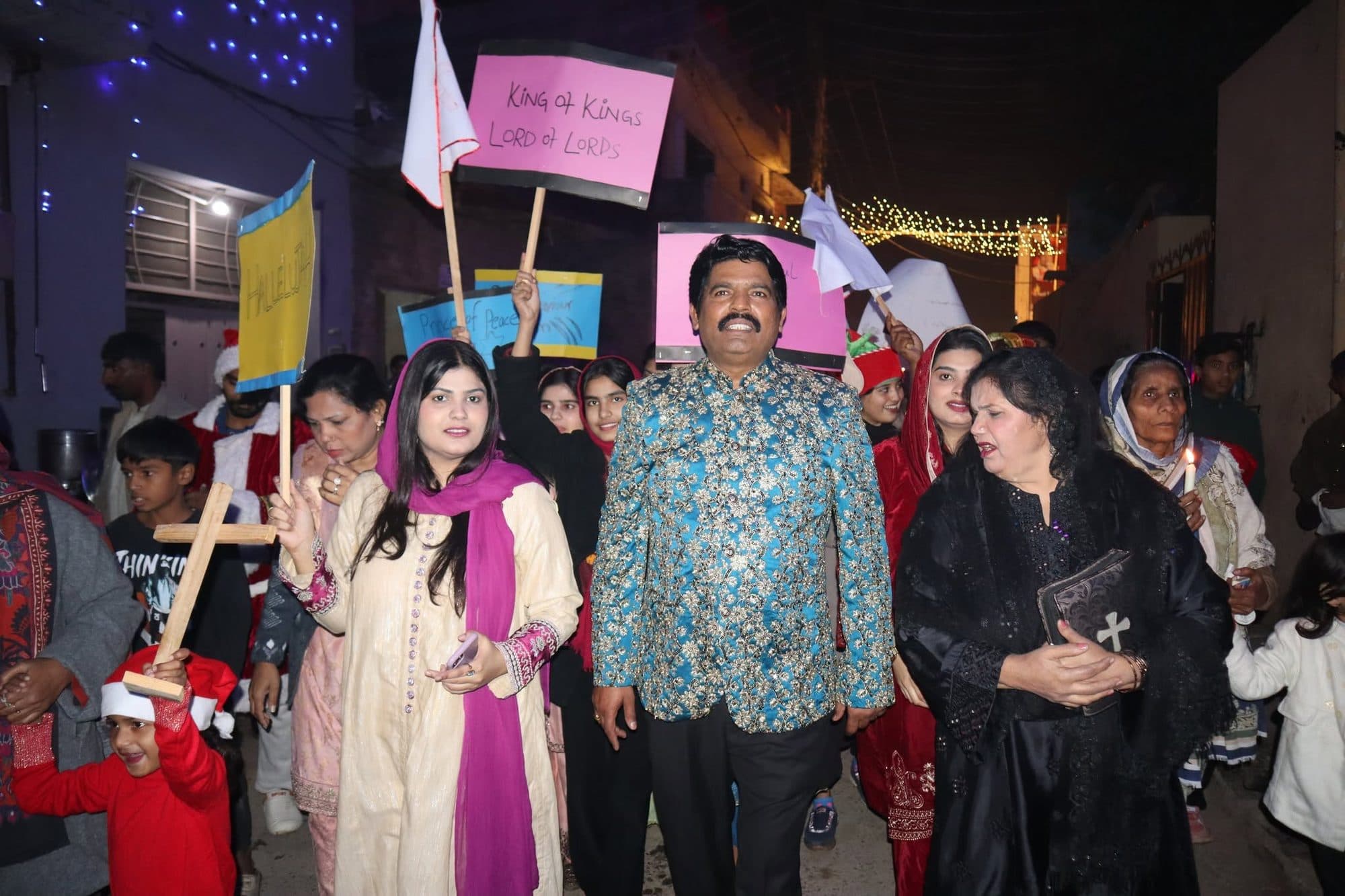 The Christmas procession walking through the lit-up streets with candles and banners