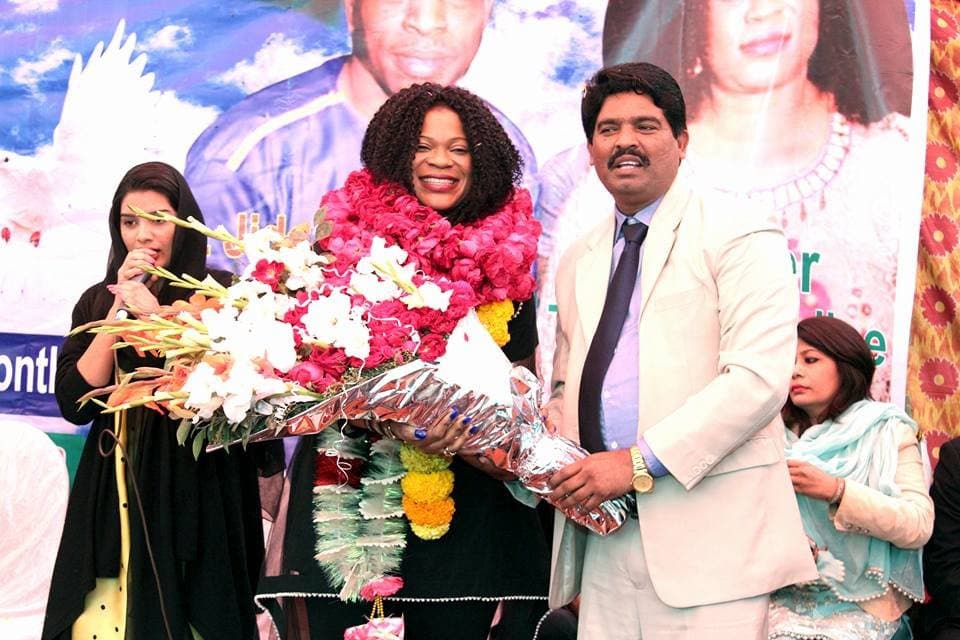 Pastor Arshad Sadiq welcoming a guest speaker with flowers and garlands
