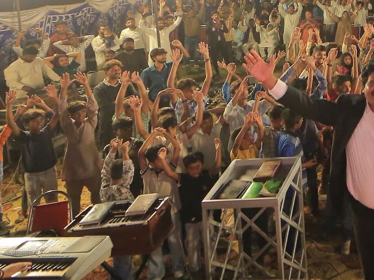 Children worshipping at the front of the gathering