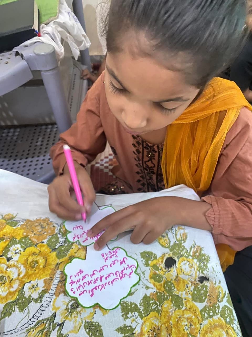 A girl writing a Bible verse during Sunday school