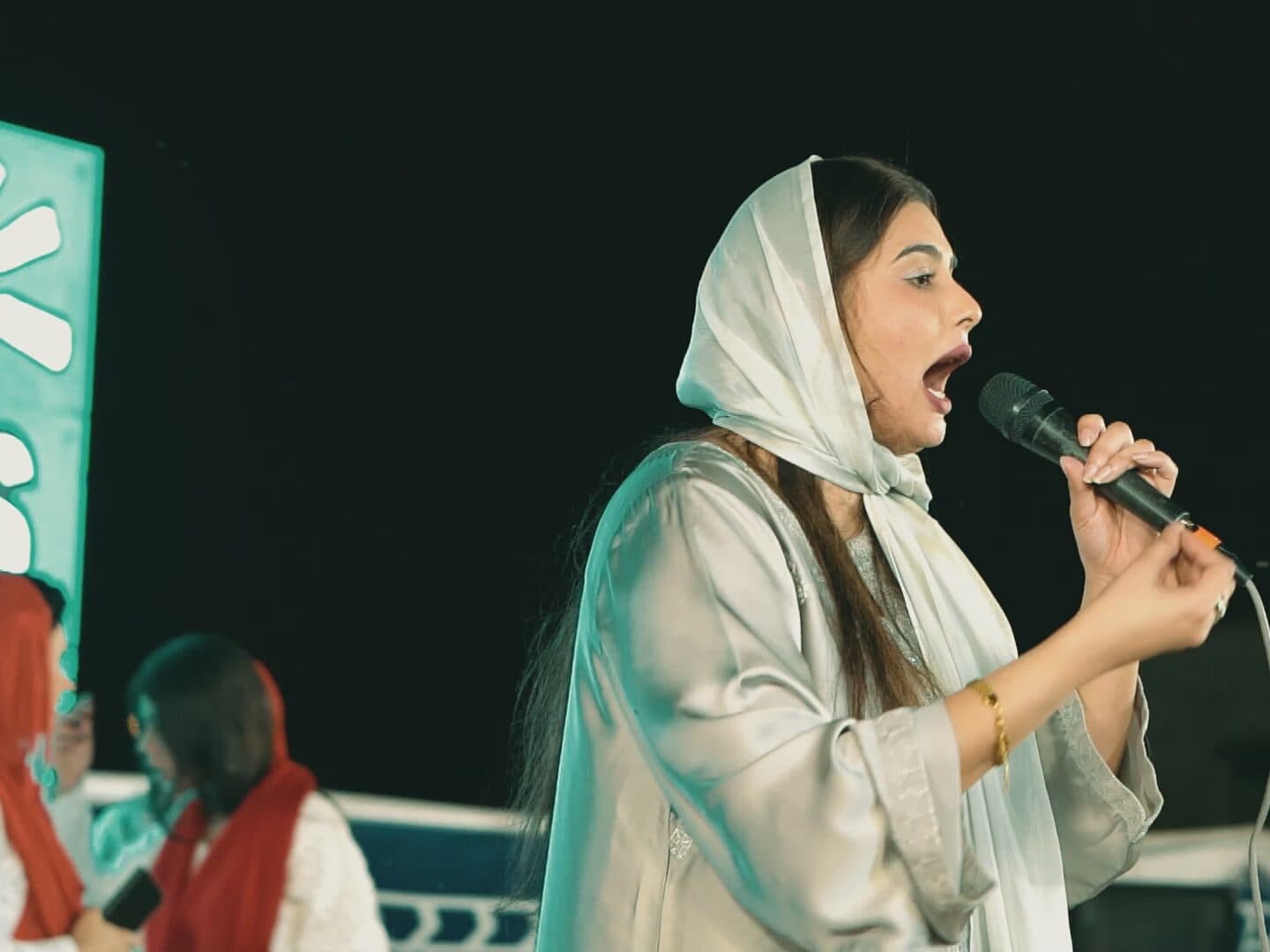 A worship leader singing on stage
